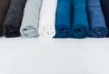 Stack of t-shirt rolled up on white background Royalty Free Stock Photo