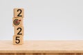 stack of 2025 with target icon on wooden cube