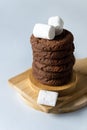 Stack of Tasty Chocolate Cookies on Wooden Cutting Board Blue Background Vertical Royalty Free Stock Photo