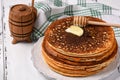 Stack of tasty cornmeal pancakes with butter and honey for breakfast