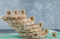 Stack of tasty crispbread with wooden letters on blue background