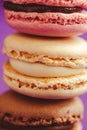 Stack of tasty macarons including vanilla, chocolate and strawberry flavours. Royalty Free Stock Photo