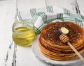 Stack of tasty cornmeal pancakes with butter and honey