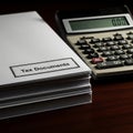 Stack of Tax Documents with Calculator Royalty Free Stock Photo