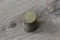 Stack of ten euro cent coins on wooden background Royalty Free Stock Photo