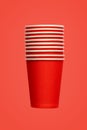stack of ten red paper eco-friendly cups on red background. empty space. environmental problems concept. simplicity Royalty Free Stock Photo