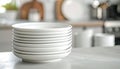 Stack of ten white ceramic plates on gray marble countertop in modern kitchen Royalty Free Stock Photo