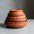 A stack of terracotta bowls arranged in descending size order, featuring earthy hues Royalty Free Stock Photo