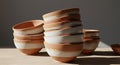 Stack of terracotta bowls with a smooth, matte finish and a distinct white band Royalty Free Stock Photo