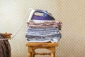 A stack of textile bed sheets blankets with iron on top f Royalty Free Stock Photo