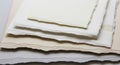 A stack of textured, deckle-edged papers Royalty Free Stock Photo