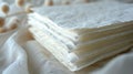 Stack of textured white paper sheets on a soft white fabric background Royalty Free Stock Photo