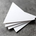 Stack of Textured White Paper Triangles on Gray Background Royalty Free Stock Photo