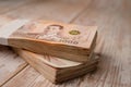 Stack of Thai baht banknotes on wooden background, business saving finance investment. Royalty Free Stock Photo