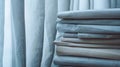 A stack of thick opaque curtains drawn closed symbolizing how privacy materials can shield and safeguard against prying