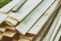 Stack of thin boards lay a bunch of light beige building patterns