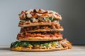 stack of thin-crust pizzas with various toppings, each pizza distinctively different Royalty Free Stock Photo