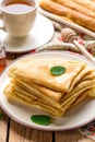 Stack of thin pancakes crepes bliny served with honey