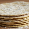 A stack of thin, round flatbreads dusted with powdered sugar. The flatbreads have a Royalty Free Stock Photo