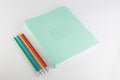 Stack of thin student notebooks with colored pencils Royalty Free Stock Photo