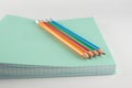 Stack of thin student notebooks with colored pencils Royalty Free Stock Photo