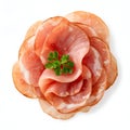 Stack of thinly sliced cured meats arranged in a circular pattern with fresh parsley garnish Royalty Free Stock Photo