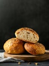 A stack of three bagels sitting on top of a wooden cutting board Royalty Free Stock Photo