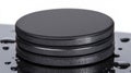 A stack of three black circular objects with a glossy finish. Royalty Free Stock Photo