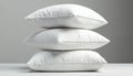 Stack of three clean white pillows on light surface against neutral grey background. Soft, comfortable bedding objects, perfect Royalty Free Stock Photo
