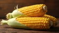 Stack of three ears of corn with husks partially peeled back on a rustic wooden surface closeup view Royalty Free Stock Photo