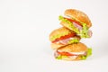 Stack of three falling hamburgers standing on a light background Royalty Free Stock Photo