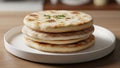 A stack of three flatbreads sits neatly on a plain white plate Royalty Free Stock Photo