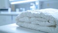 Stack of three folded white comforters on a medical examination table Royalty Free Stock Photo