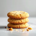 Stack of Three Golden Cookies on a White Marble Surface in Bright Light Royalty Free Stock Photo