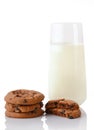 Stack of three homemade chocolate chip cookies, halves of cookies and glass of milk Royalty Free Stock Photo