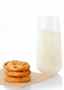 Stack of three homemade peanut butter cookies on baking paper and glass of milk Royalty Free Stock Photo