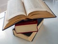 A stack of three old books that lie on top of each other. Background for libraries, science, education Royalty Free Stock Photo