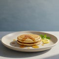 A stack of three pancakes is arranged on a large, round plate. They are topped with a Royalty Free Stock Photo