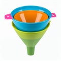Stacking colorful kitchen funnels of various sizes, vibrant colors, and design on white background Royalty Free Stock Photo