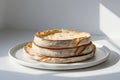 Stack of three round flatbreads on a white plate with soft lighting and shadows on a white surface Royalty Free Stock Photo