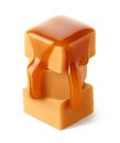 Stack of three sweet caramel candy cubes topped with caramel sauce on white background Royalty Free Stock Photo