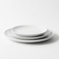 Stack of Three White Ceramic Plates on White Background Keywords: plates, ceramic, white, stack, dishware, tableware, kitchen, Royalty Free Stock Photo