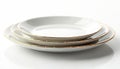 Stack of three white ceramic plates with thin gold rims sit on clean white surface. Elegant dishes ready for fine dining special Royalty Free Stock Photo