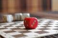 Stack of three white plastic dices and one red dice on brown wooden board background. Six sides cube with black dots. Number 3, 2 Royalty Free Stock Photo