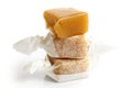 Stack of three wrapped vanilla caramel toffees . One unw Royalty Free Stock Photo
