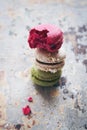 Stack of three yummy macaroons on rustic background