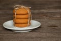 A stack of tied cookies with a rope lies on an wooden table Royalty Free Stock Photo