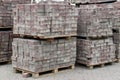 Stack of tiles on the sidewalk, pavement stones stacked on pallet at the street. Royalty Free Stock Photo