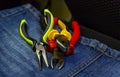 Stack of tools hand pliers colorful non-slip handles work with power tools industrial background Royalty Free Stock Photo