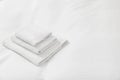 Stack of towels on clean linens indoors, space for text Royalty Free Stock Photo